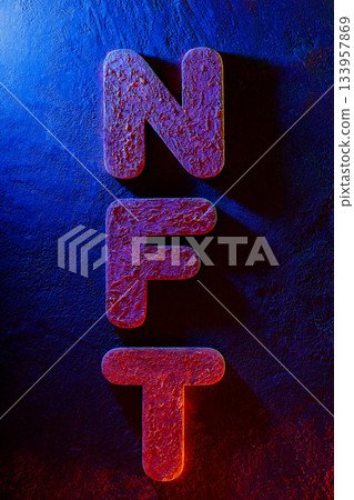NFT Letters Illuminated by Neon Lighting on Textured Surface 133957869