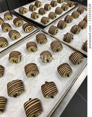 Buttery and flaky pain au chocolat with a golden, crispy crust and rich, melted chocolate filling. A classic French pastry perfect for breakfast or an indulgent snack. 133958326