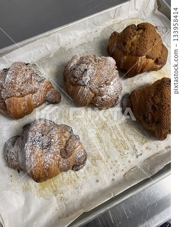 A croissant is a classic French pastry known for its buttery, flaky layers and golden crust. Often enjoyed plain or filled with chocolate, almond, or ham and cheese, it’s a perfect for breakfast A croissant is a classic French pastry known for its buttery, flaky layers and golden crust. Often enjoyed plain or filled with chocolate, almond, or ham and cheese, it’s a perfect for breakfast 133958414