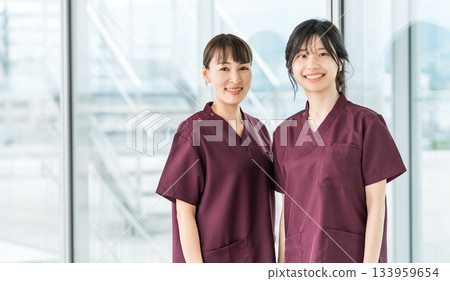 Female staff of doctors, physicians, nurses, medical professionals, doctors, occupational therapists and physical therapists wearing scrubs 133959654