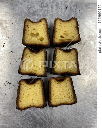 Canelé, a classic French pastry with a caramelized crust and soft, custard-like center, infused with vanilla and rum. Perfect for dessert photography, showcasing the elegant texture and rich flavor. 133960151