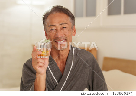Senior man drinking alcohol at night Senior man drinking alcohol at night 133960174