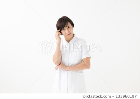 A worried woman in a white coat A worried woman in a white coat 133960197