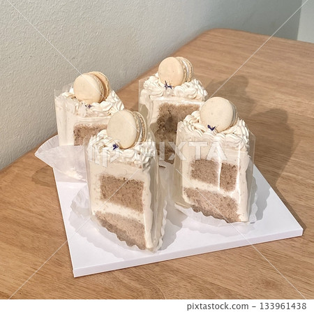 A delectable slice of cake with rich layers of cream and frosting, topped with fresh fruit or sprinkles. Perfect for dessert photography, showcasing indulgence and sweetness in food-related projects. 133961438