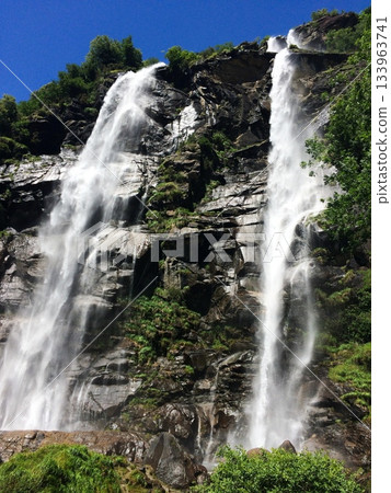 Tall Mountain Waterfall in Forest 133963741