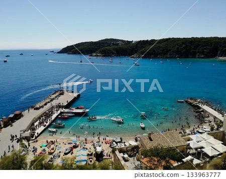 Crowded Beach with Pier and Turquoise Water Crowded Beach with Pier and Turquoise Water 133963777