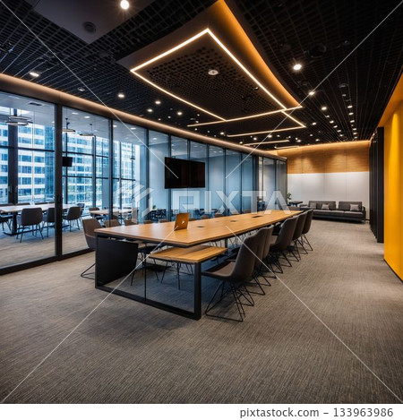 Boardroom with dark ceiling and geometric lights over a long table 133963986