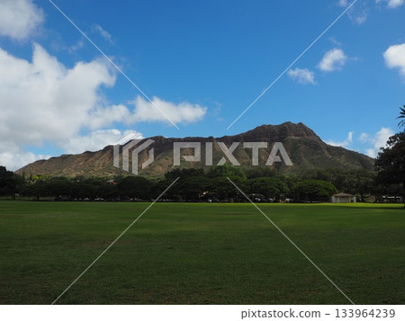 A symbol of Hawaii: the majestic Diamond Head and blue sky seen from Kapiolani Park 133964239