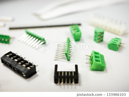 Assorted electronic connectors and terminal blocks on white background, close-up of electronic components for PCB assembly. 133966103