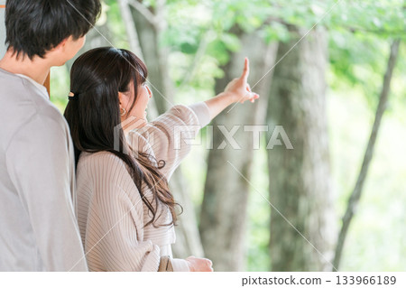A couple staying at a hot spring inn and Japanese-style room on a domestic trip and looking at the garden view A couple staying at a hot spring inn and Japanese-style room on a domestic trip and looking at the garden view 133966189