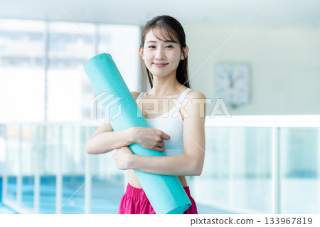 Young woman training in a sports gym Young woman training in a sports gym 133967819