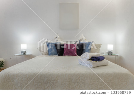 Bright Cozy Bedroom with Soft Bedding and Decorative Pillows 133968759