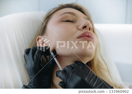 young woman getting Mesotherapy facelifting procedure in aesthetic clinic. Beauty treatment 133968902