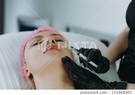 young woman getting an injection procedure in aesthetic clinic. Beauty treatment young woman getting an injection procedure in aesthetic clinic. Beauty treatment 133968903