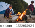 childrent at camping fire campfire in the dusk looking at flame 133968924