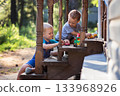 cute little children playing on porch in countryside 133968926