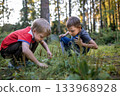 little children playing in garden squatting in the grass 133968928