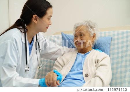 Asian doctor checking and treat elderly woman patient health in hospital. Asian doctor checking and treat elderly woman patient health in hospital. 133971510