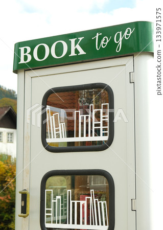 Book to go. Public street book-sharing kiosk with free community books for readers 133971575