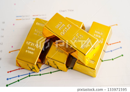 Gold bars on graph paper, finance trading investment business currency. Gold bars on graph paper, finance trading investment business currency. 133971595