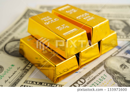 Gold bars on US dollar banknote money, finance trading investment business currency concept. 133971600