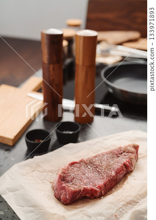 closeup raw seasoned new york steak on concrete countertop background 133971893