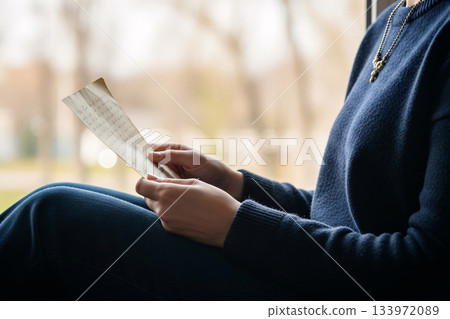 Woman Holding Vintage Love Letter By Window Light 133972089
