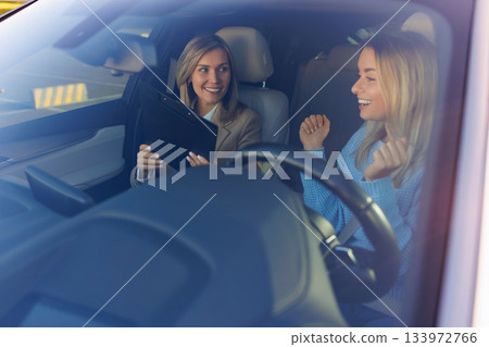 Driving Instructor Reviewing Test Results with Learner Driver Driving Instructor Reviewing Test Results with Learner Driver 133972766