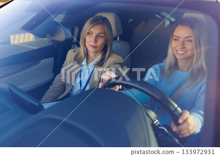 Driving Lesson Success with Confident Student and Calm Instructor Driving Lesson Success with Confident Student and Calm Instructor 133972931