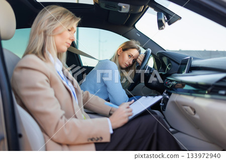Young Woman Feeling Anxious at Steering Wheel During Driving Test Evaluation 133972940