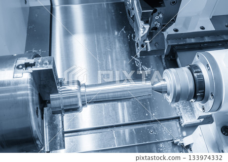 The operation CNC lathe machine finish cut the metal shaft parts in the light blue scene. The operation CNC lathe machine finish cut the metal shaft parts in the light blue scene. 133974332