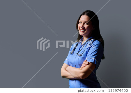 Profile portrait of confident middle-aged woman doctor, nurse on grey background 133974400