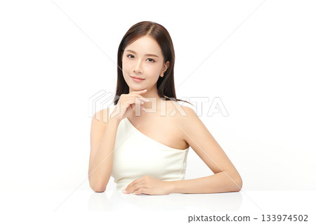 A beautiful young Asian woman with clean, fresh skin against a white background. Skincare, facial treatment, cosmetology, beauty, and spa. An elegant portrait of an Asian woman. A beautiful young Asian woman with clean, fresh skin against a white background. Skincare, facial treatment, cosmetology, beauty, and spa. An elegant portrait of an Asian woman. 133974502