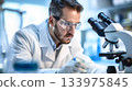 Medical man scientist working at microscope in laboratory. 133975845