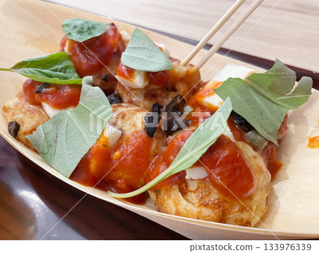 Italian-style takoyaki: Takoyaki topped with tomatoes and basil. Italian-style takoyaki: Takoyaki topped with tomatoes and basil. 133976339