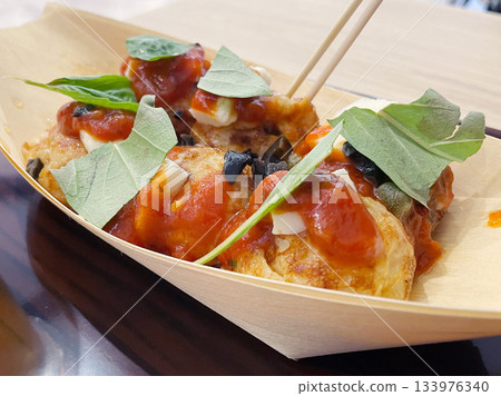 Italian-style takoyaki: Takoyaki topped with tomatoes and basil. Italian-style takoyaki: Takoyaki topped with tomatoes and basil. 133976340
