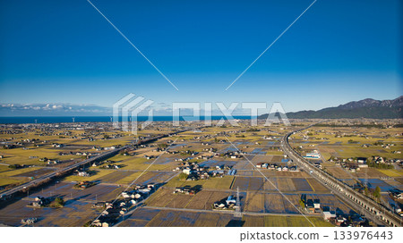 Scenery of the Kurobe River alluvial fan, the Northern Alps, the Shinkansen viaduct, and the Hokuriku Expressway in early December Scenery of the Kurobe River alluvial fan, the Northern Alps, the Shinkansen viaduct, and the Hokuriku Expressway in early December 133976443