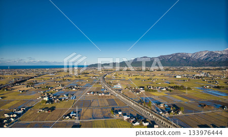 Scenery of the Kurobe River alluvial fan, the Northern Alps, the Shinkansen viaduct, and the Hokuriku Expressway in early December Scenery of the Kurobe River alluvial fan, the Northern Alps, the Shinkansen viaduct, and the Hokuriku Expressway in early December 133976444