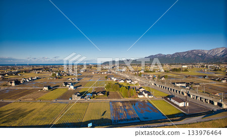 Scenery of the Kurobe River alluvial fan, the Northern Alps, the Shinkansen viaduct, and the Hokuriku Expressway in early December 133976464