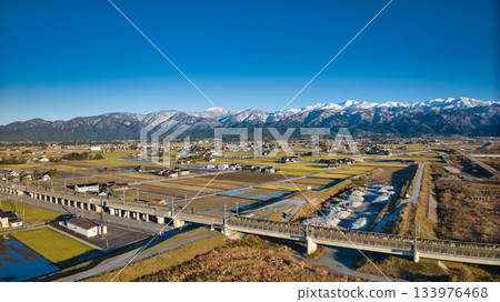 Scenery of the Kurobe River alluvial fan, the Northern Alps, the Shinkansen viaduct, and the Hokuriku Expressway in early December 133976468
