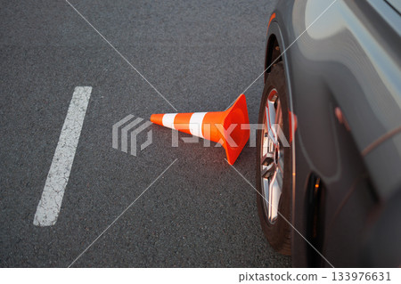 Traffic Cone Knocked Down Beside Car Wheel During Driving Lessons Traffic Cone Knocked Down Beside Car Wheel During Driving Lessons 133976631