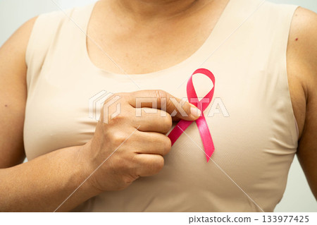 Asian woman with pink ribbon for October world breast cancer day. 133977425