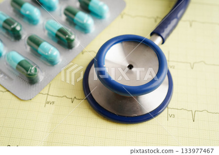 Stethoscope on electrocardiogram (ECG), heart wave, heart attack, cardiogram report. Stethoscope on electrocardiogram (ECG), heart wave, heart attack, cardiogram report. 133977467
