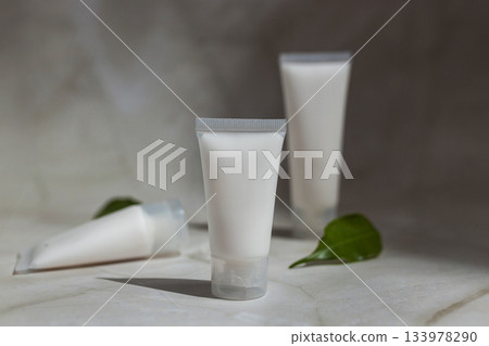 Minimalist skincare mockup with blank cosmetic tubes and green leaves on marble surface, ideal for natural beauty products, organic branding, clean cosmetics and modern wellness design. Minimalist skincare mockup with blank cosmetic tubes and green leaves on marble surface, ideal for natural beauty products, organic branding, clean cosmetics and modern wellness design. 133978290