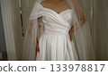 Bride wearing white wedding dress and veil 133978817