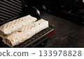 Shawarmas grilling in panini press for snack 133978828