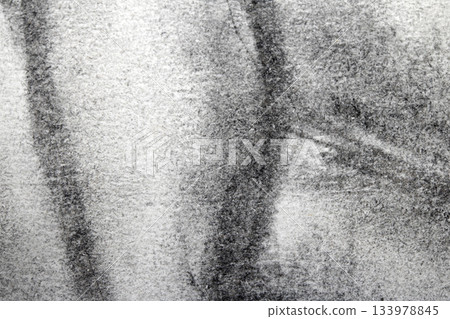 Close up of smudged charcoal on white paper faded background Close up of smudged charcoal on white paper faded background 133978845