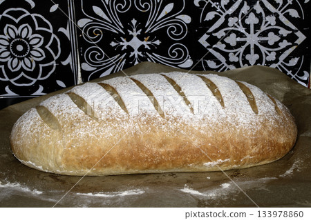 Close up of home made freshly baked bloomer of bread Close up of home made freshly baked bloomer of bread 133978860
