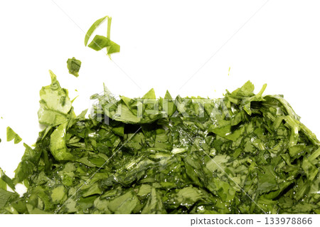 Close up of chopped coriander and parsley herbs on a white background 133978866
