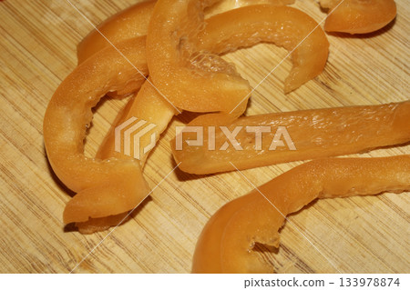 Close up of chopped sliced sweet pepper on a wooden chopping board 133978874